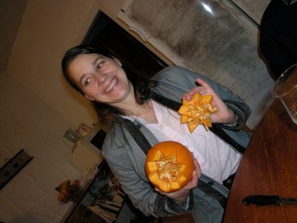 Anna carving a pumpkin