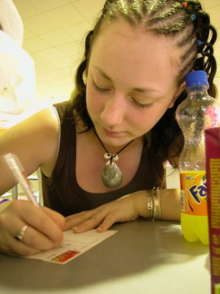 Kirsty writing a postcard