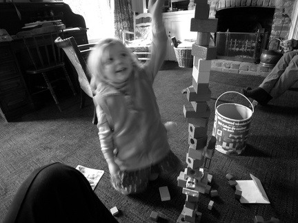 Grace playing with a tower of wooden blocks